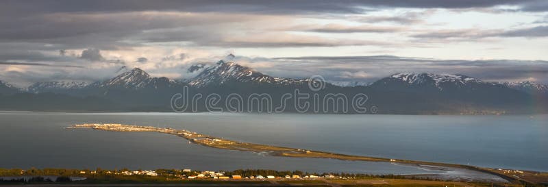 A beautiful view of Homer Alaska, the Kenai Mountains, Kachemak Bay and the world famous Homer Spit from the overlook on East End Road in Homer, Alaska. A common summer cruise ship port of call, located on the very end of the Kenai Peninsula and part of the Pacific Ocean Ring of Fire, Homer is famous for commercial and recreational fishing, particularly halibut, outdoor recreation opportunities, and its eclectic artist vibe is popular with both Alaskans and tourists alike. A beautiful view of Homer Alaska, the Kenai Mountains, Kachemak Bay and the world famous Homer Spit from the overlook on East End Road in Homer, Alaska. A common summer cruise ship port of call, located on the very end of the Kenai Peninsula and part of the Pacific Ocean Ring of Fire, Homer is famous for commercial and recreational fishing, particularly halibut, outdoor recreation opportunities, and its eclectic artist vibe is popular with both Alaskans and tourists alike.