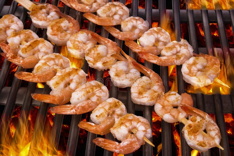 Delicious prawn spit on grill with flames in background. Delicious prawn spit on grill with flames in background