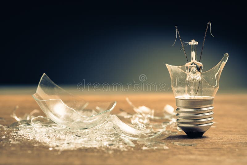 Broken light bulb with pieces of glass, creative idea concept. Broken light bulb with pieces of glass, creative idea concept