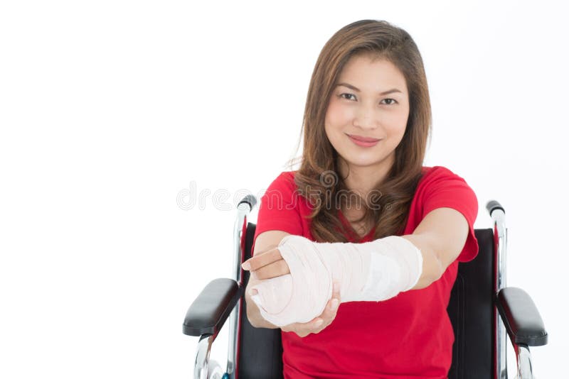 Broken arm Asian woman with plaster cast in her hands sitting on. 