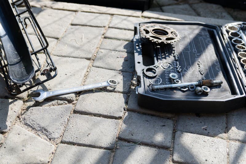 Broken Bike, Wheel and Axle Replacement. in the Background of Tools and