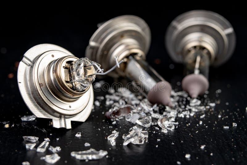 Broken Bulb for the Car Headlight. Spilled Glass and Broken Filament on