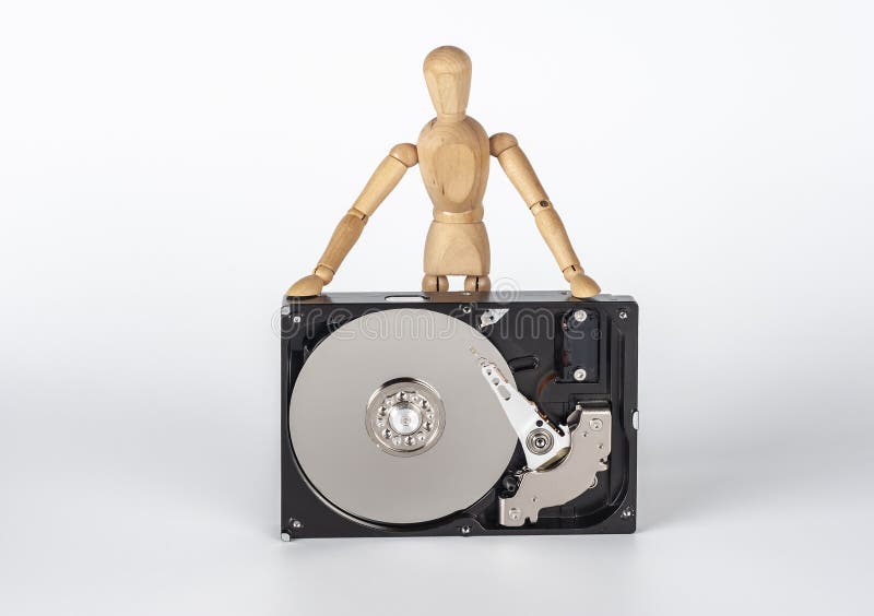 A wooden man is repairing a hard drive.