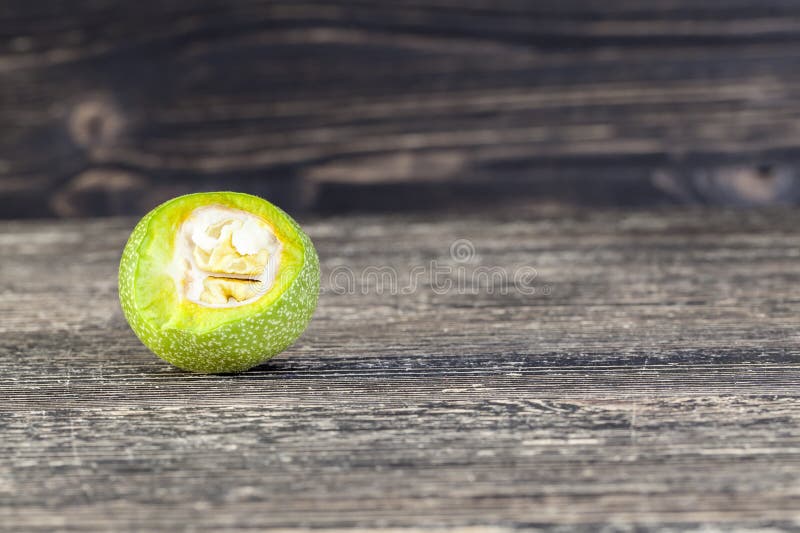 Cut green walnut stock images