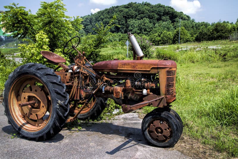broken-down-vintage-red-tractor-old-junkyard-44894473.jpg