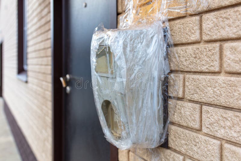 Broken Electric Meter Wrapped in Duct Tape on the Wall Stock Photo