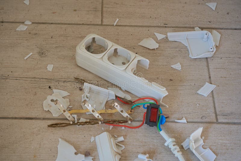 Pieces of a broken electrical extension cord, poor quality plastic, worn out electrical extension cord. Damaged extension cord stock images, royalty-free photos and pictures