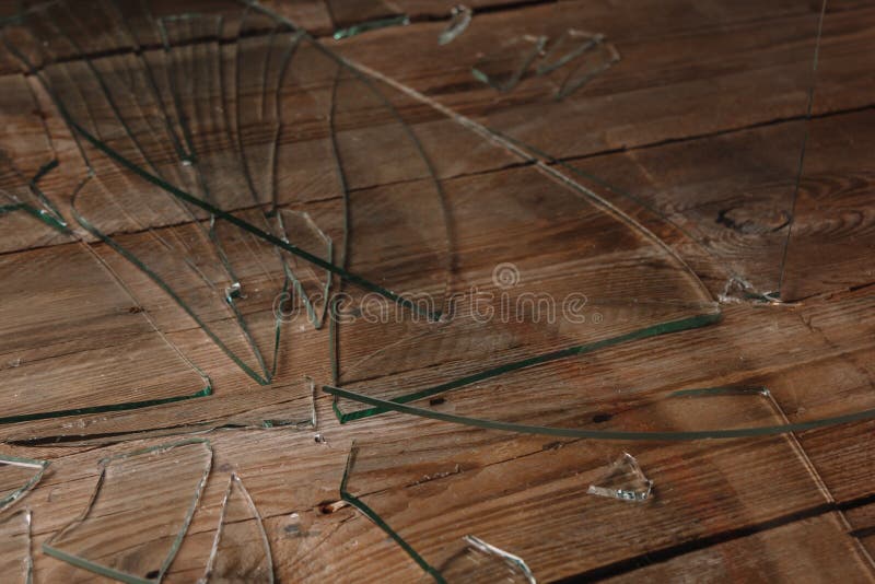 Broken Glass on an Old Wooden Floor, Concept of Violence Stock Photo