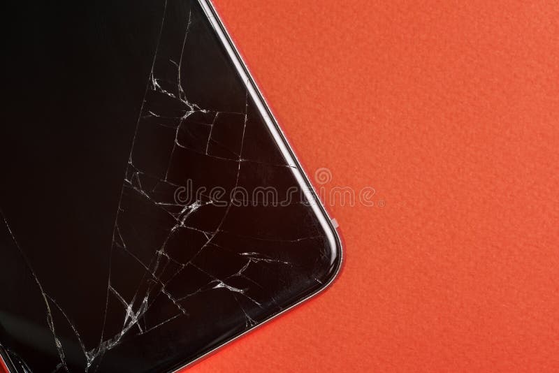 Broken glass of the phone screen. Black mobile phone with a broken screen. Smartphone on a red background close-up. Top view, flat stock photos Broken glass of the phone screen. Black mobile phone with a broken screen. Smartphone on a red background close-up. Top view, flat stock photos
