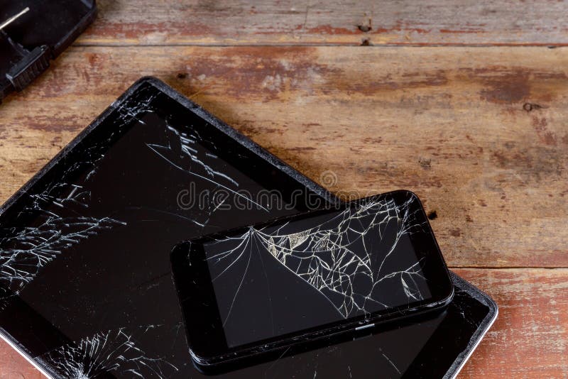 Broken Smart Phone and Tablet on Cracked Touch Screen Stock Photo