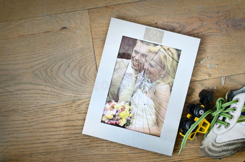 Broken photo frame of a married couple with children going for divorce. Broken photo frame of a married couple with children going for divorce