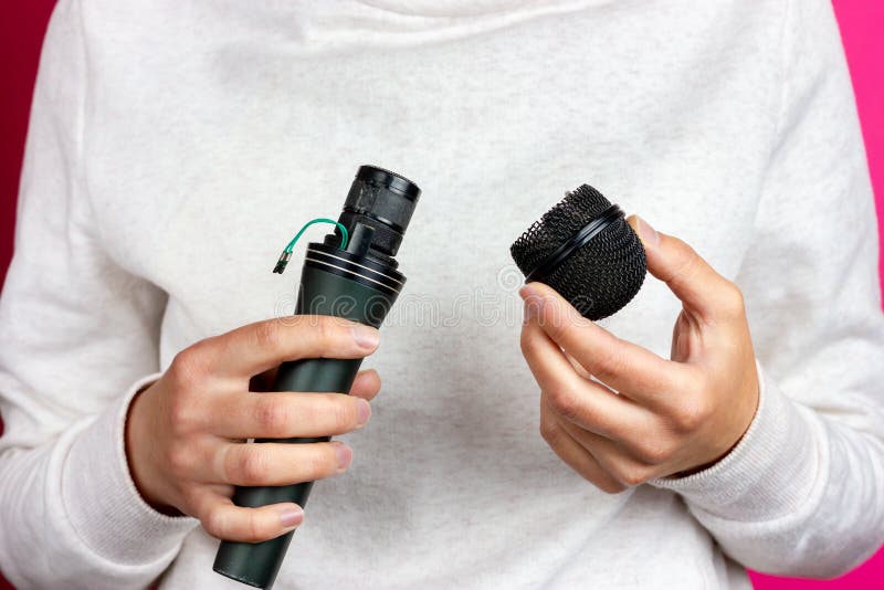 Broken Microphone in Hand. Broken Mesh Microphone Stock Photo Image