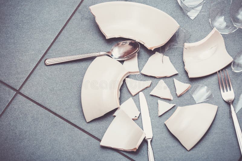 Broken Plate or Broken Water Glass on the on the Floor in the Kitchen
