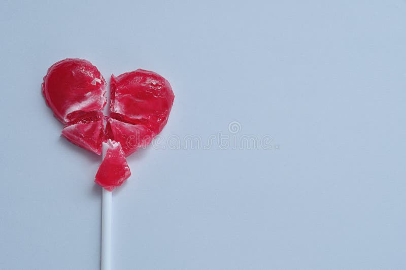 A broken red heart lollipop symbolizing a broken heart royalty free stock image A broken red heart lollipop symbolizing a broken heart royalty free stock image