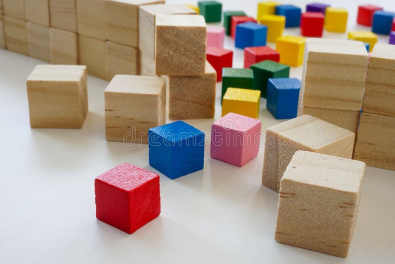 Broken wall made of cubes and colored ones as a concept of diversity, inclusion and anti-discrimination. royalty free stock photos