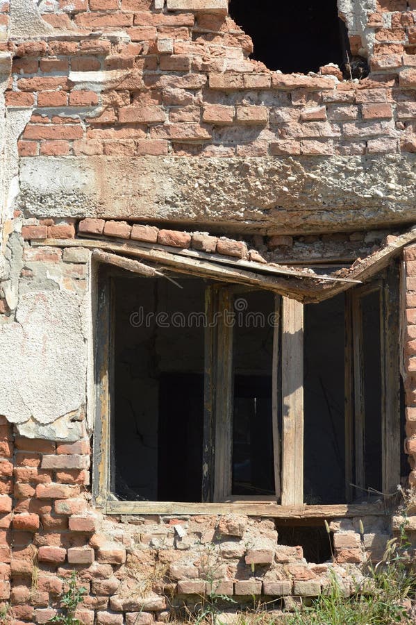 Broken wooden window on an old ruined house stock photos