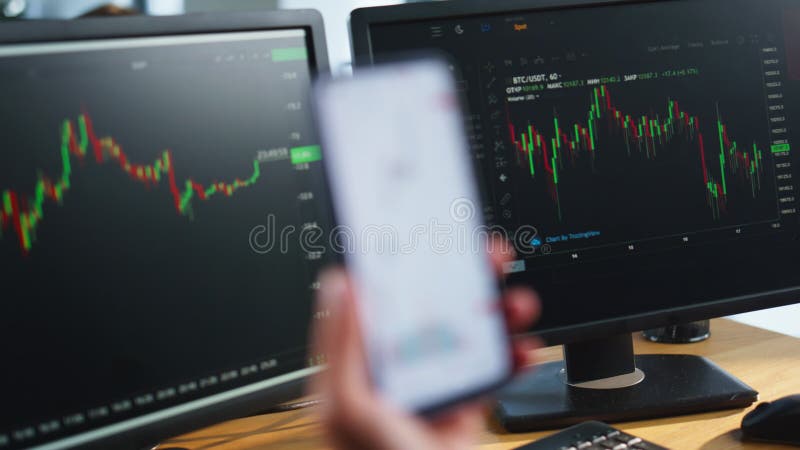 Broker hands holding mobile phone with stock market charts at office closeup. stock video