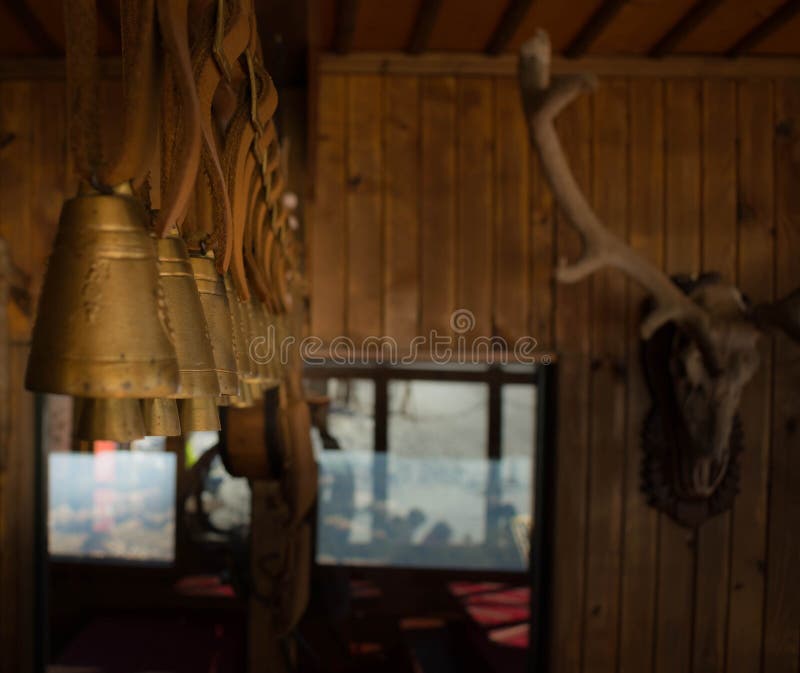 Bronze bells in a row hanging in a wooden cabin. Traditional big metal pot stock images, royalty-free photos and pictures