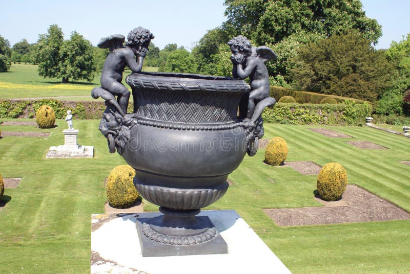 Bronze sculptured urn at a topiary garden