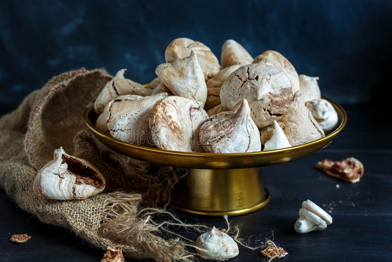 Bronze Stand with Chocolate Meringue and Old Sackcloth. Stock Photo