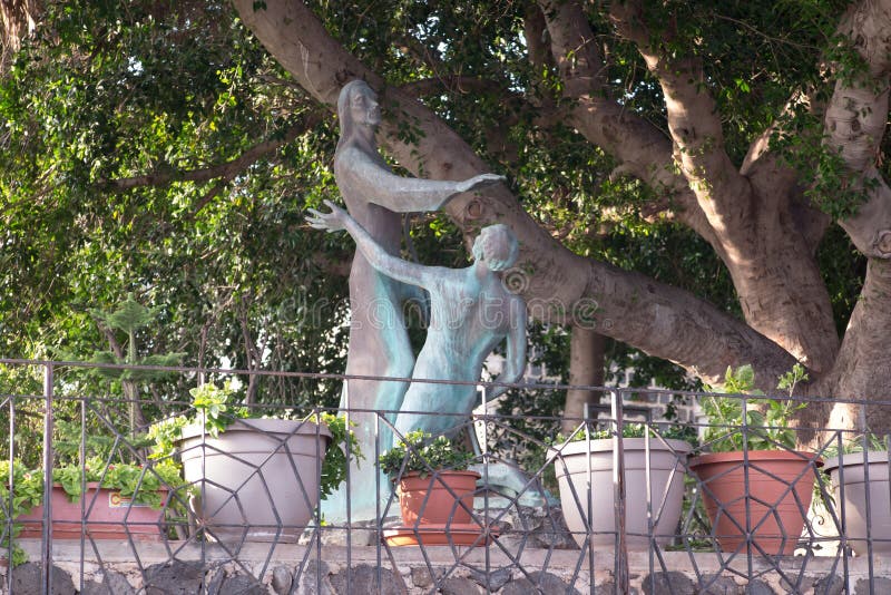 Bronze statue standing in the courtyard of the Church of the Primacy of St. Peter, located on the shores of the Sea of Galilee in