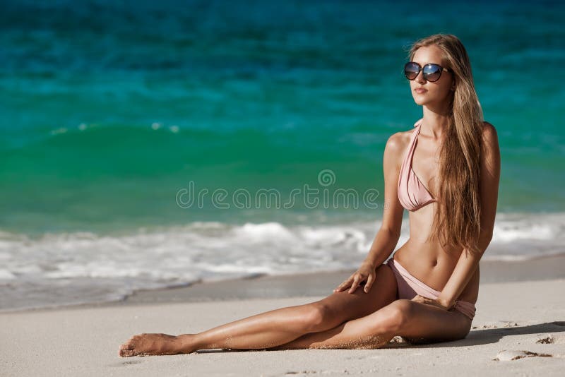 Bronze Tan Woman Sunbathing At Tropical Beach