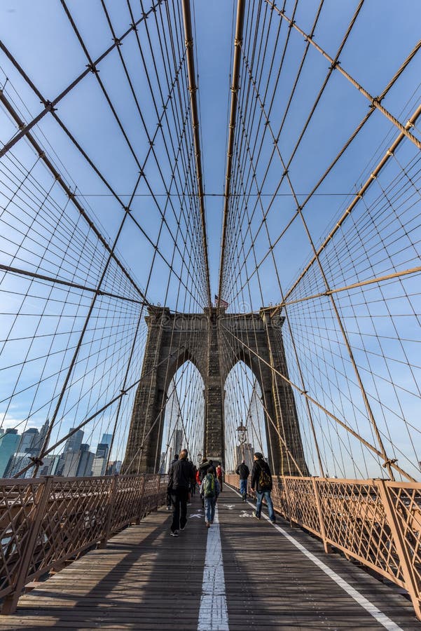 Brooklyn Bridge at Sunset with People Walking Across in View Editorial