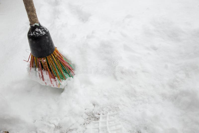 A Broom in the Snow. Snow Removal in Winter. a Broom Sweeps the Snow