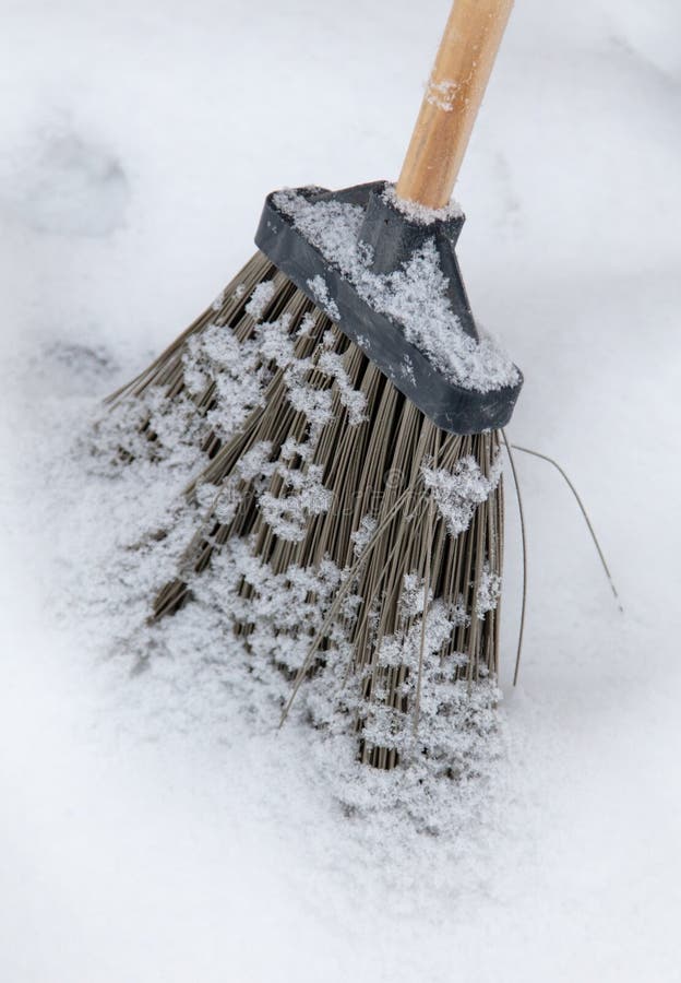 Winter. A Man With A Broom Cleans Car From Snow On The Street After Big ...