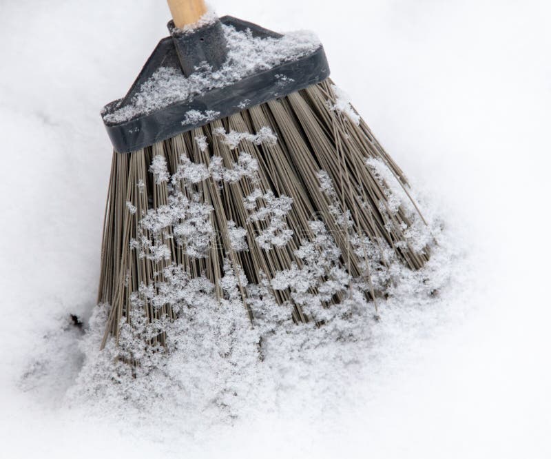 A Broom in the Snow. Snow Removal in Winter. a Broom Sweeps the Snow