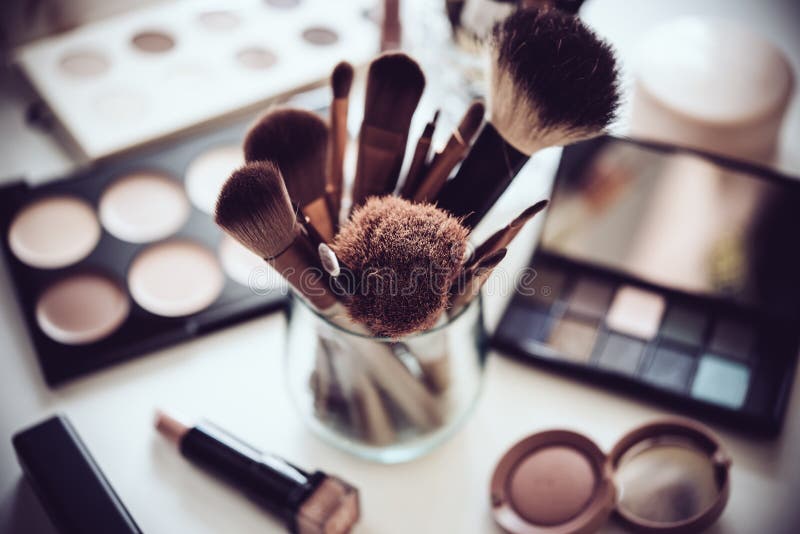 Professional makeup brushes and tools, natural make-up products set on white table. Professional makeup brushes and tools, natural make-up products set on white table.