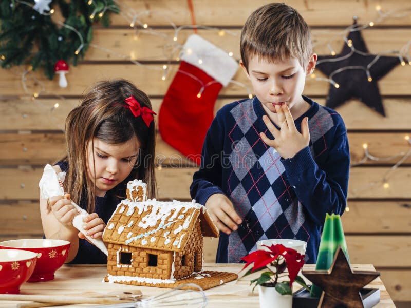 Brother and sister decorating gingerbread house royalty free stock photo Brother and sister decorating gingerbread house royalty free stock photo