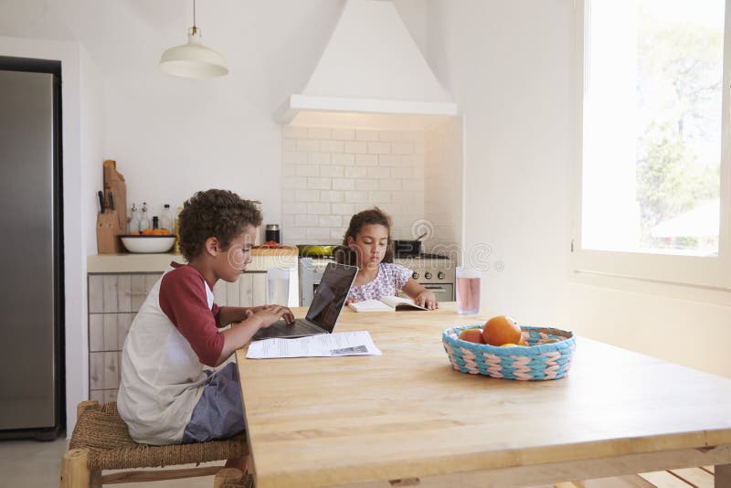 doing homework at the kitchen table