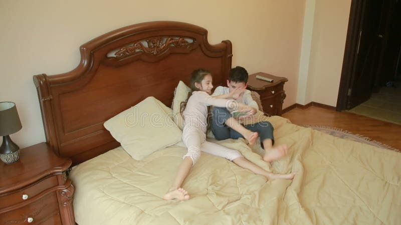 Brother and Sister Fights and Pushes Each Other at Home in the Parents` Bedroom. Fighting for the Phone Stock Footage - Video of problem, brother: 89869508 