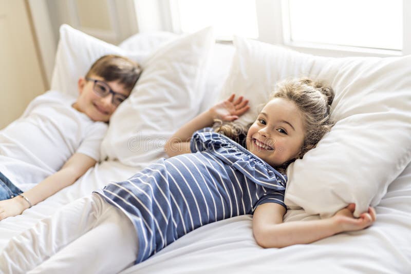 Brother And Sister having fun Together on Bed. 