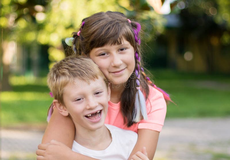 Brother and Sister are Hugging Each Other in a Sunny Day in the Park ...