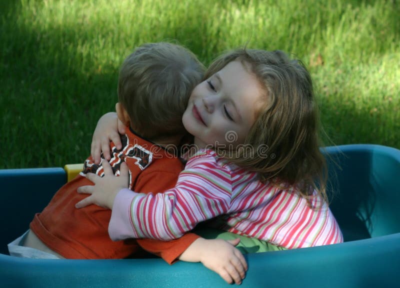 Brother and sister hugging