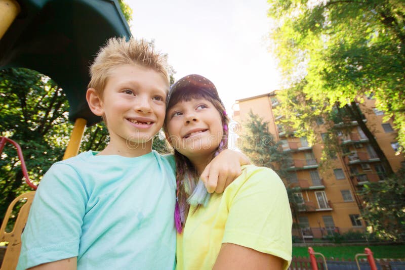 Brother and sister are hugging each other in a sunny day in the park royalty free stock photos
