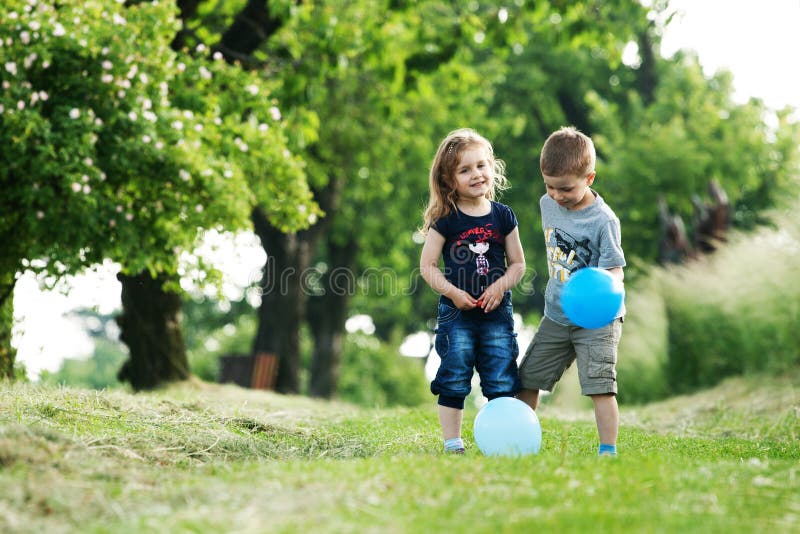 Brother and sister outdoor portrait with balloons
