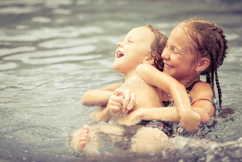 Happy Brother And Sister Playing In Swimming Pool Stock 