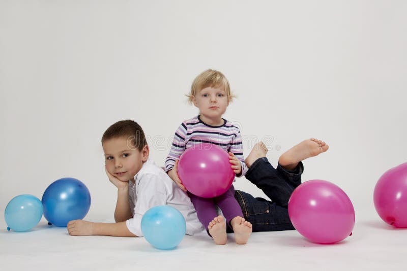 Brother and sister portrait with balloons
