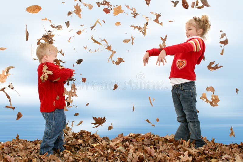 Happy two year old boy and five year old sister throwing leaves at each other. Happy two year old boy and five year old sister throwing leaves at each other.