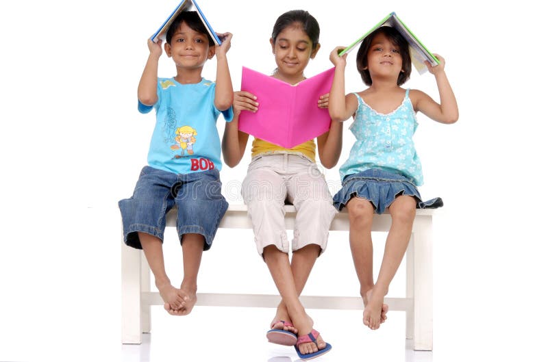 Brother and two sisters holding books