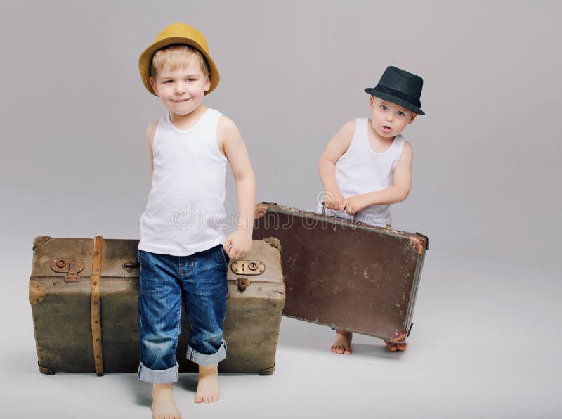 Brothers holding their heavy luggages