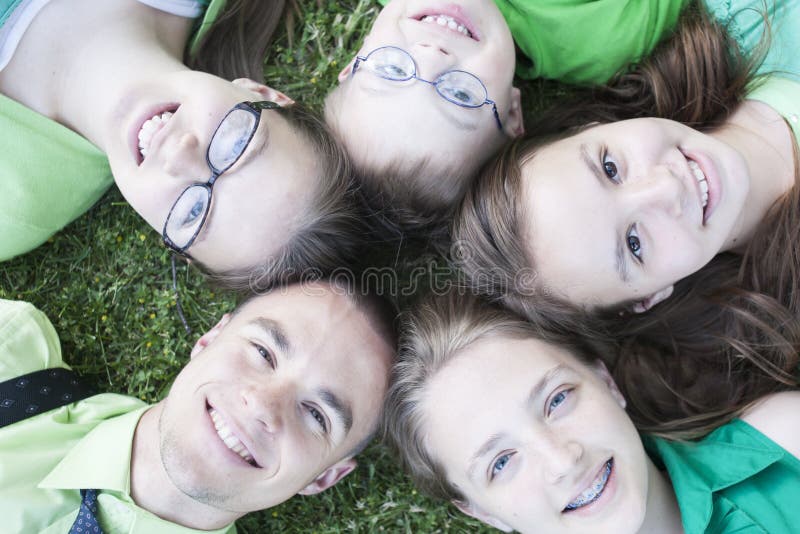 Brothers and Sisters lying in the grass stock images