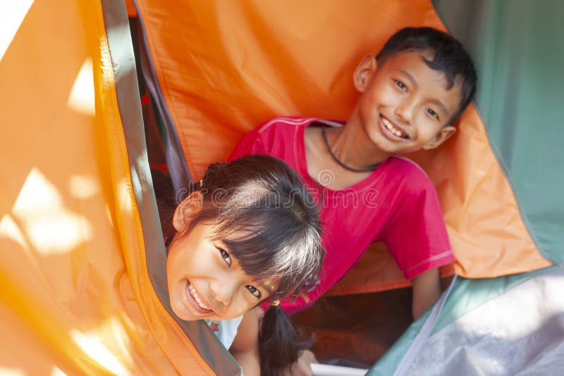 The brothers and sisters in tents while traveling go camping in holiday. royalty free stock photography The brothers and sisters in tents while traveling go camping in holiday. royalty free stock photography