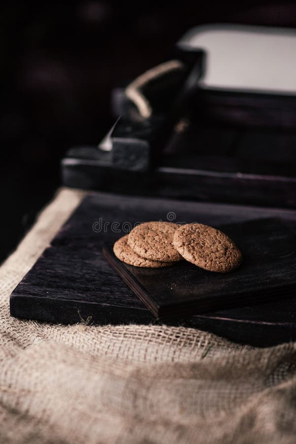 Rustic, dark and blurred background. corn. On the table are oatmeal cookies royalty free stock images