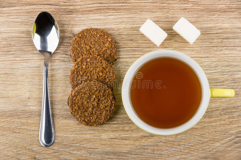 Brown Biscuits, Teaspoon, Lumpy Sugar and Cup of Tea Stock Photo Image of horizontal, sugar