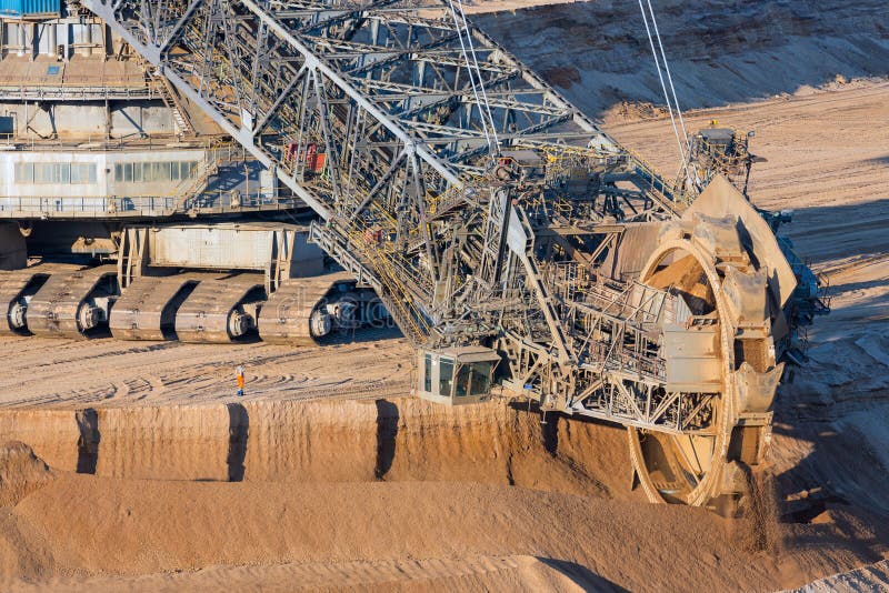Brown coal open pit landscape with digging excavators in Germany stock photography