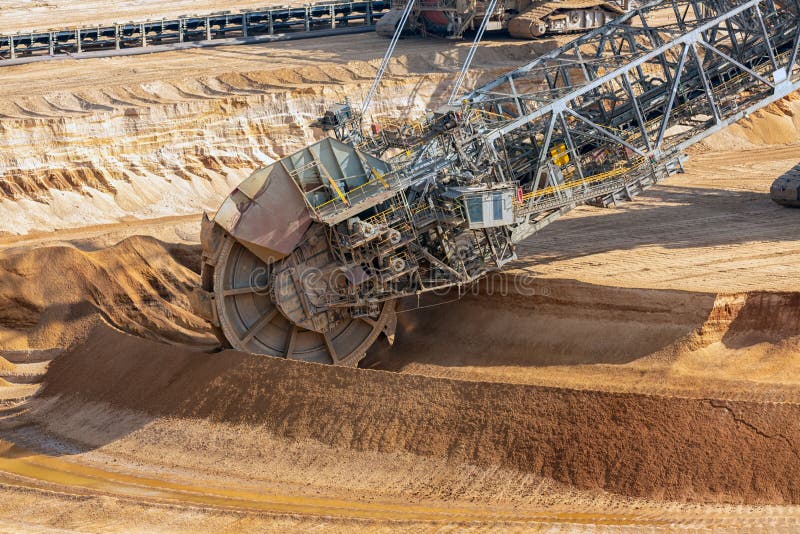 Brown coal open pit landscape with digging excavators in Germany stock photos